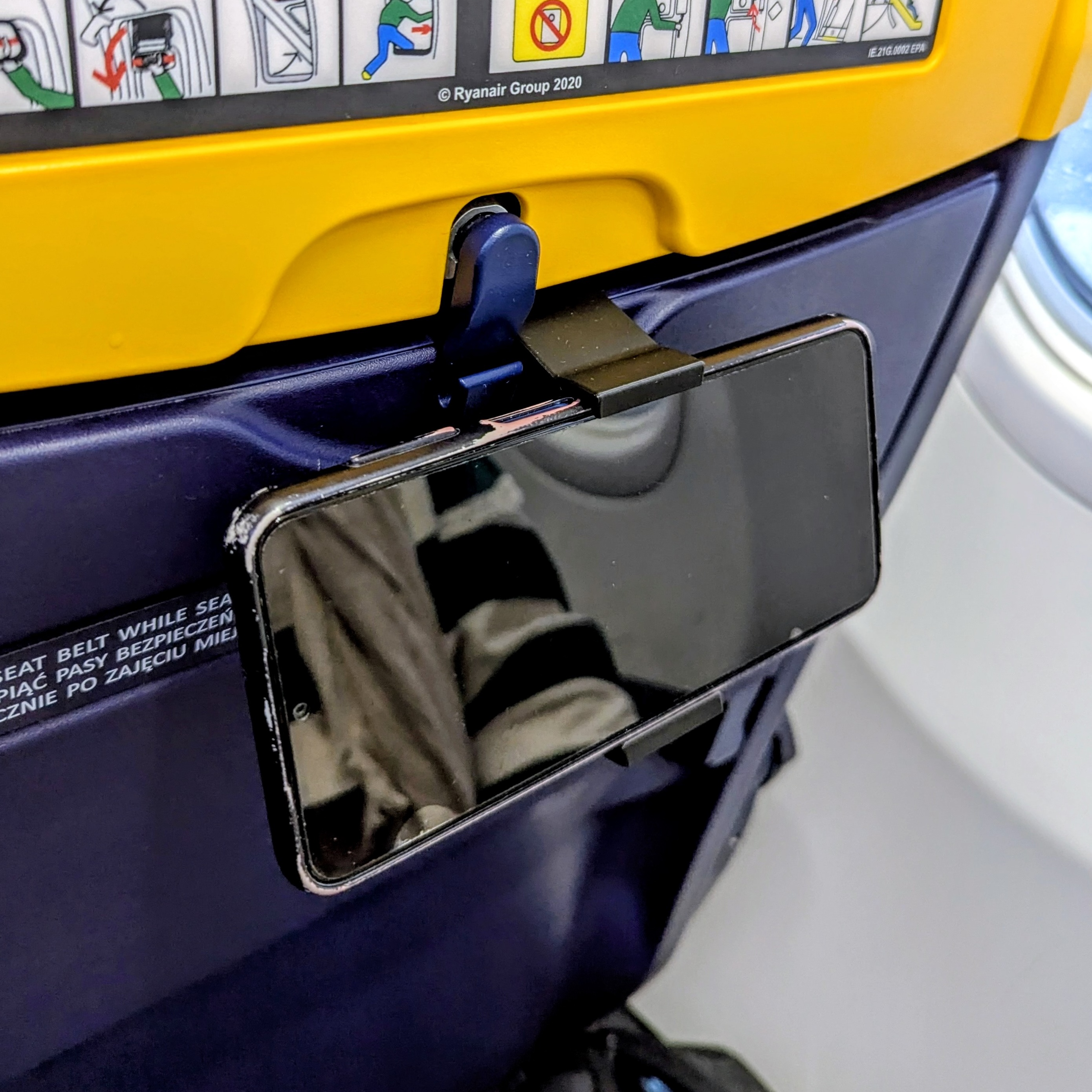 FlytHook mounted on airplane seat